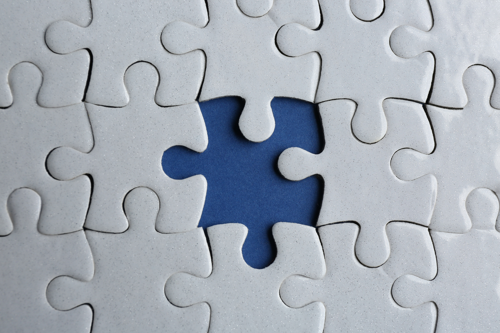 White Puzzle with Missing Piece on Blue Background, Top View. Career Promotion Concept